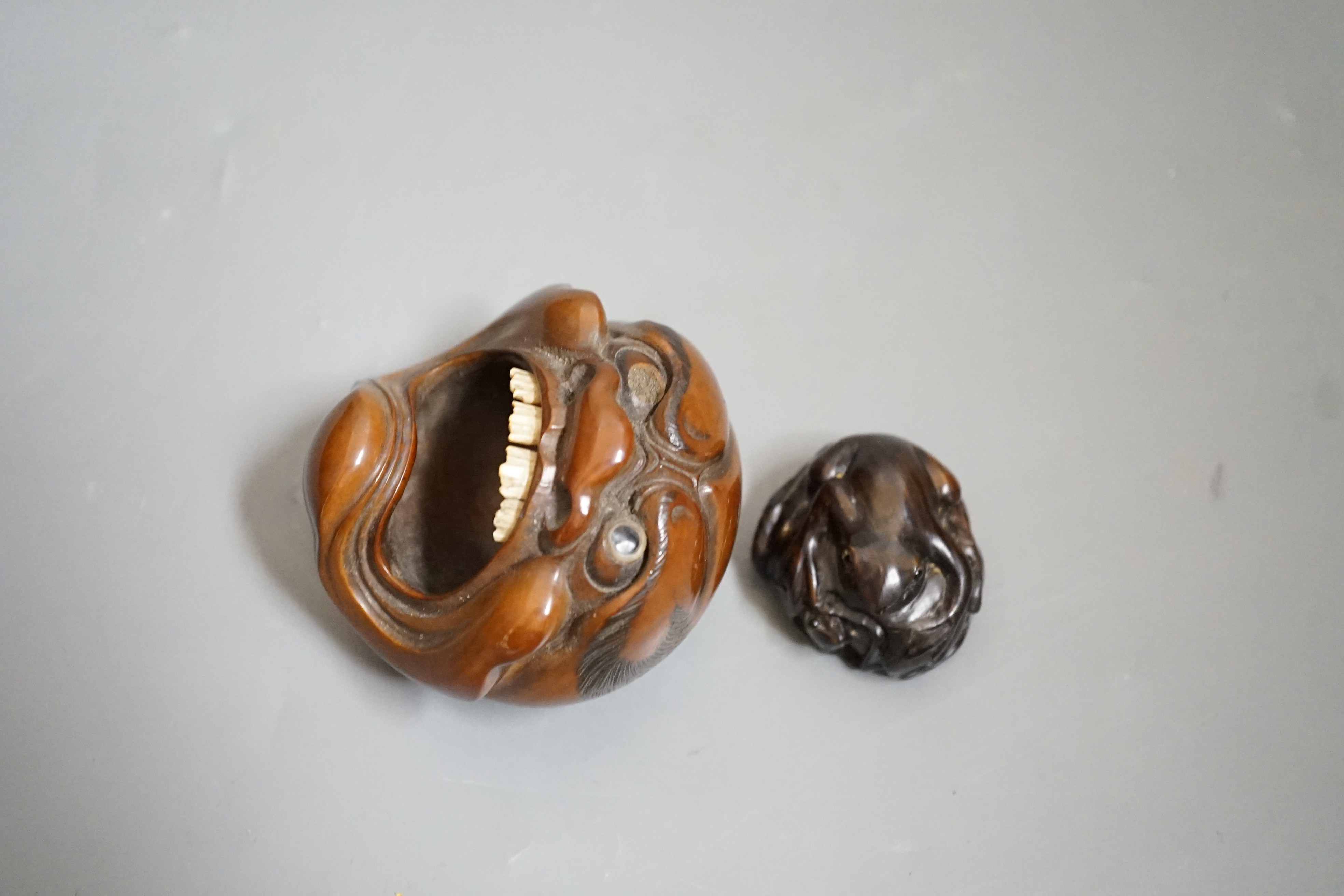 A Japanese mask nut carving wood carving, Meiji period and a netsuke of frogs, marks to bases, largest 7.5cm wide Ivory submission reference: 7BGTCJP8